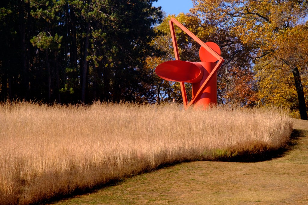 Alexander Liberman's Adam sculpture, 1970 in a field of tall grass in the North Woods area during autumn at the Storm King Art Center.